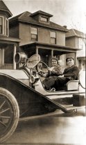 Jay Grantham and Lucy Farnsworth riding in vintage car